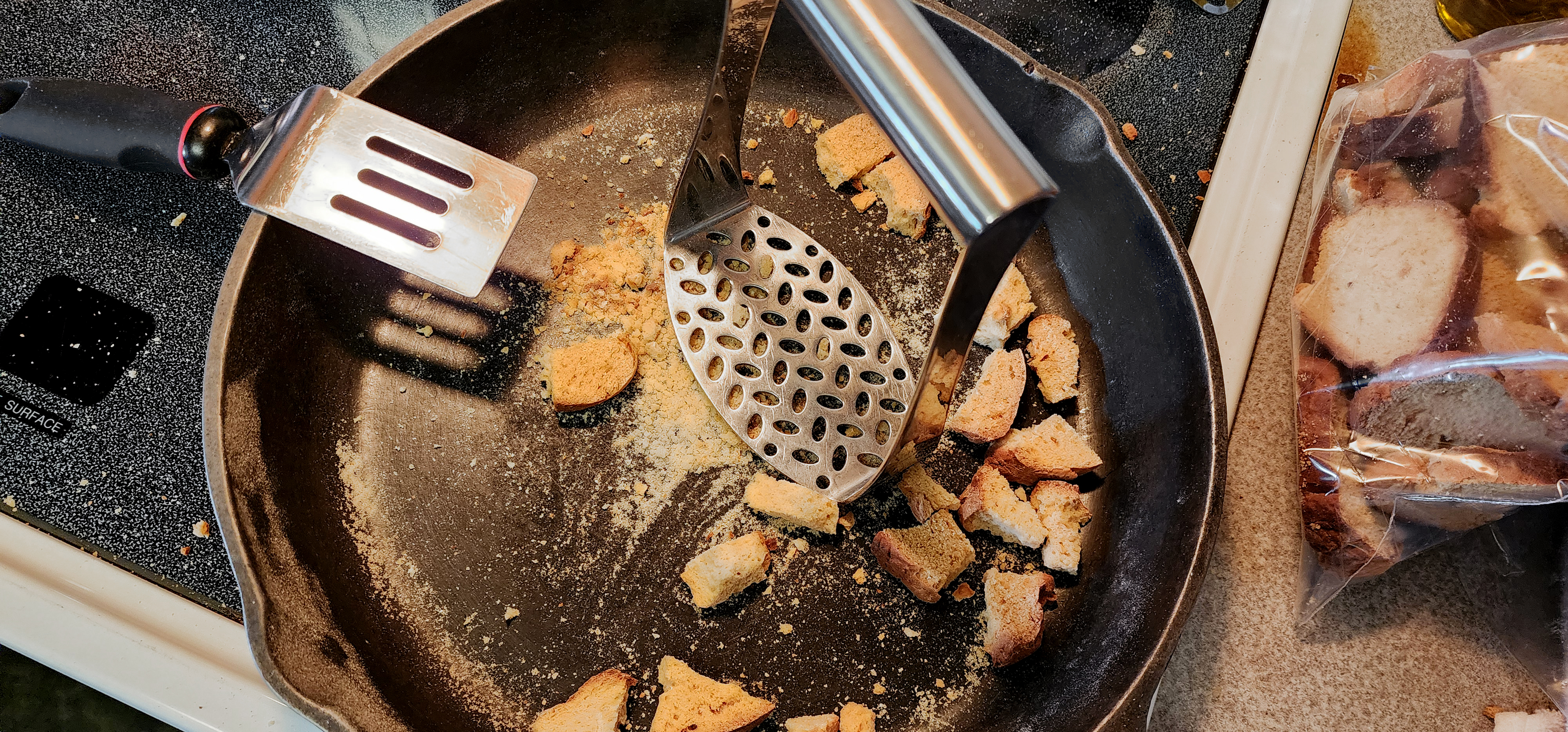 crushingg zwieback toast in a cast iron skillet><br>7. Next day cut the loaves into 1/2